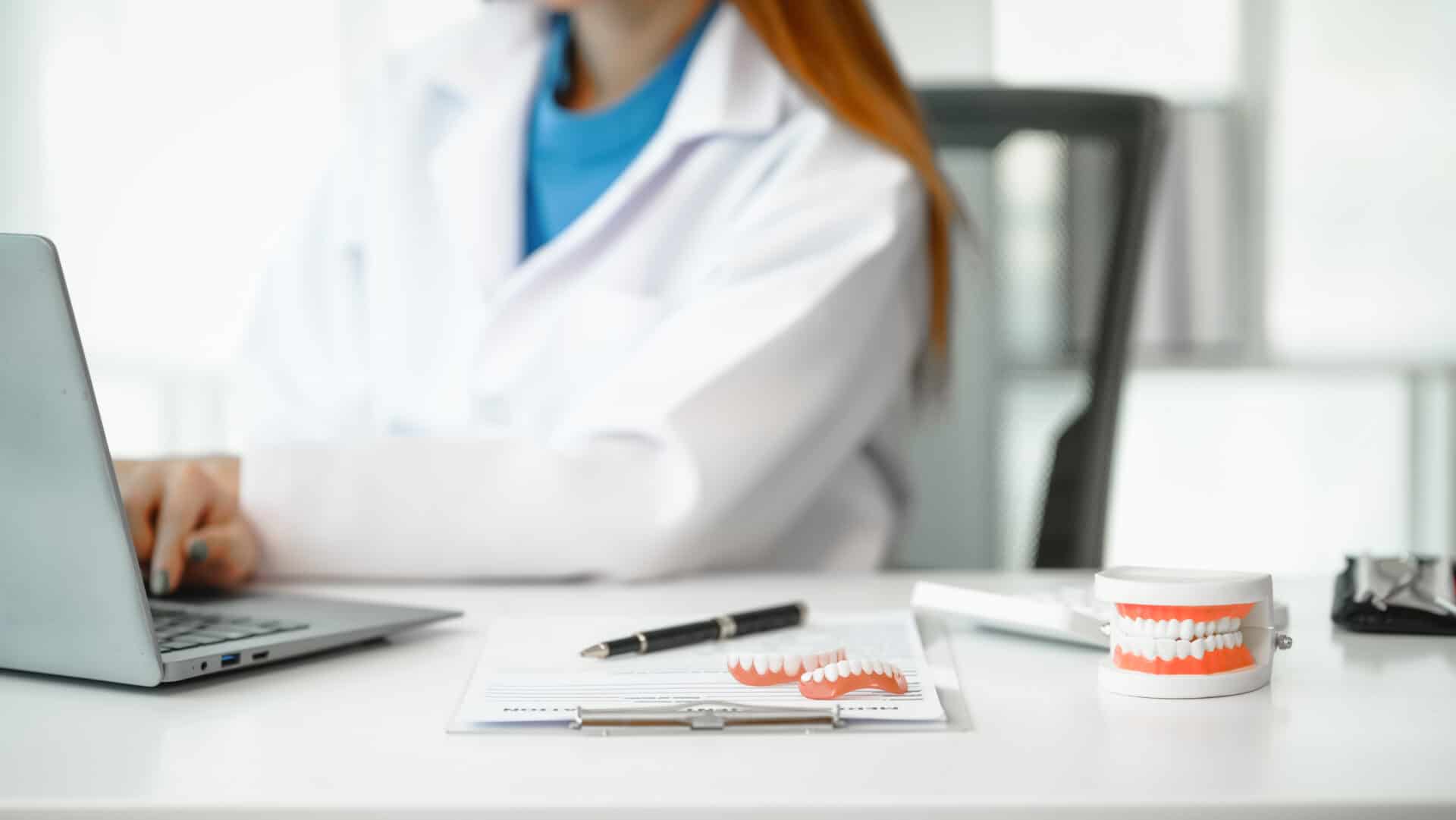 Engaging dental consultation with a female model discussing men's dental appointments at a professional desk meeting, emphasizing oral health and dental care for men.